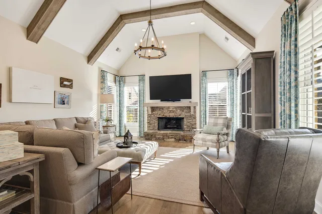 a living room with furniture a fireplace and a flat screen tv