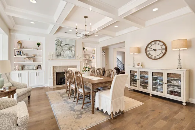 a living room with furniture a fireplace and a chandelier