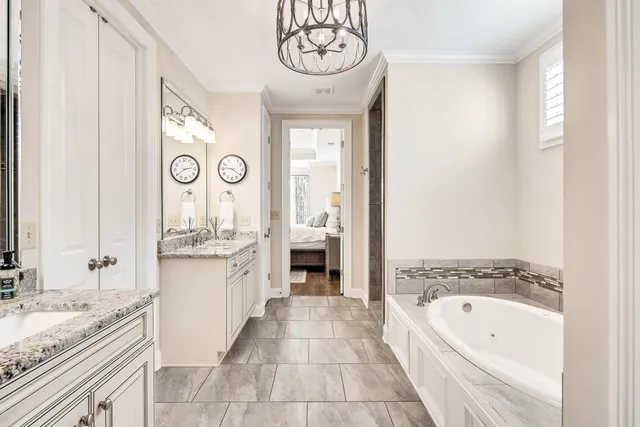 a bathroom with a granite countertop sink a toilet and bathtub