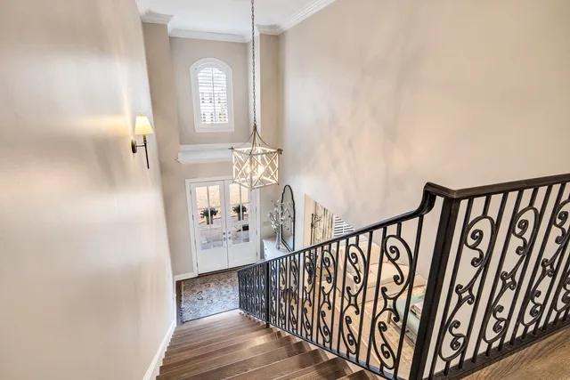 a view of a hallway with wooden floor and stairs