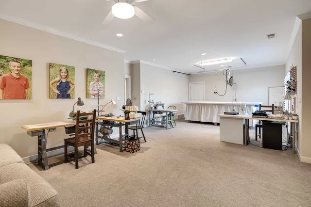 a large white kitchen with lots of furniture a sink a dining table and chairs