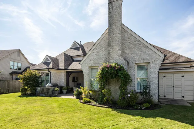 a front view of a house with garden