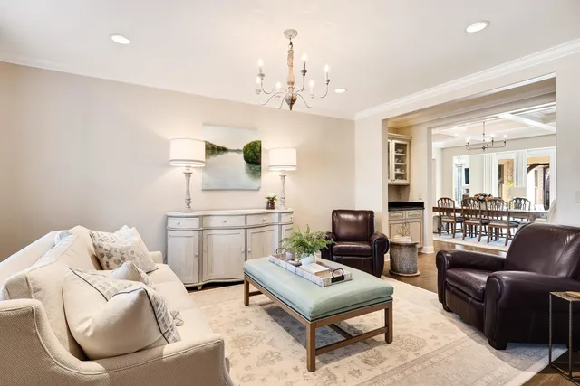a living room with furniture and a chandelier
