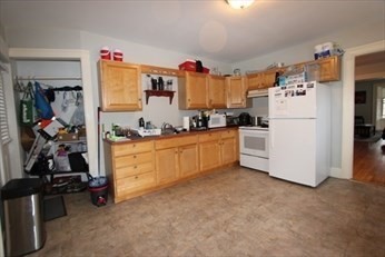122 Elm Street, Unit C Millbury, MA 01527 - Photo 2 of 11 a kitchen with white cabinets and white appliances