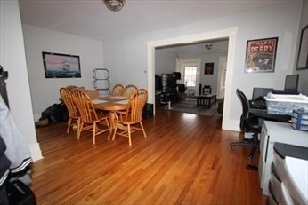 122 Elm Street, Unit C Millbury, MA 01527 - Photo 3 of 11 a view of a dining room with furniture and wooden floor