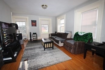 122 Elm Street, Unit C Millbury, MA 01527 - Photo 5 of 11 a living room with furniture and a window