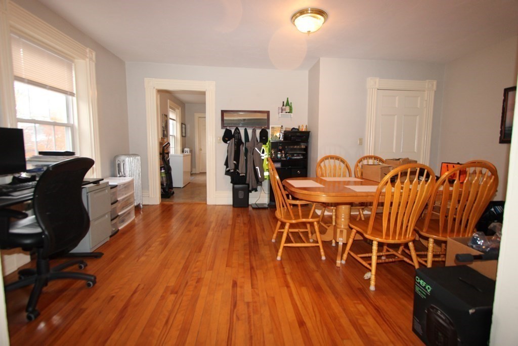 122 Elm Street, Unit C Millbury, MA 01527 - Photo 6 of 11 a dining room with furniture wooden floor and windows