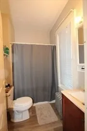 a bathroom with a sink a toilet a tub and shower