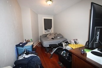 122 Elm Street, Unit C Millbury, MA 01527 - Photo 8 of 11 a bedroom with a bed and a mirror