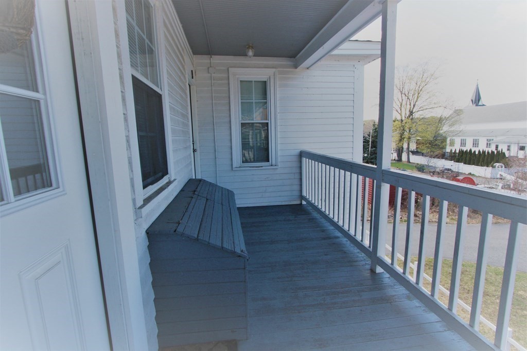 122 Elm Street, Unit C Millbury, MA 01527 - Photo 10 of 11 a view of a balcony with wooden floor