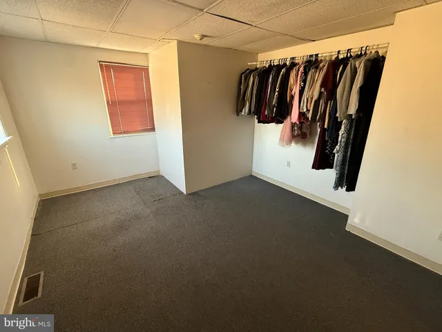 a view of walk in closet with clothes