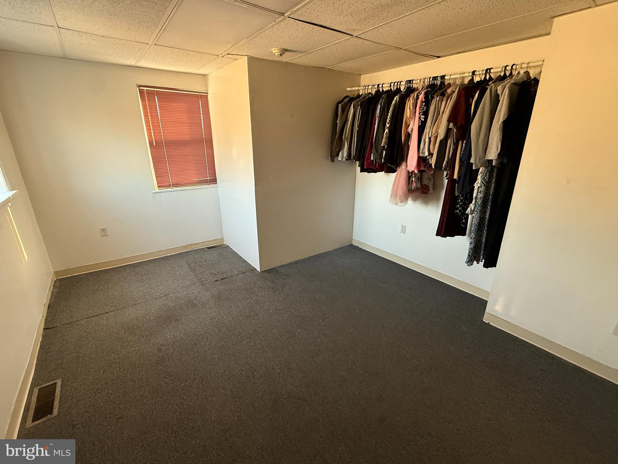 511 East Grape Street Vineland, NJ 08360 - Photo 18 of 40 a view of walk in closet with clothes and shoes