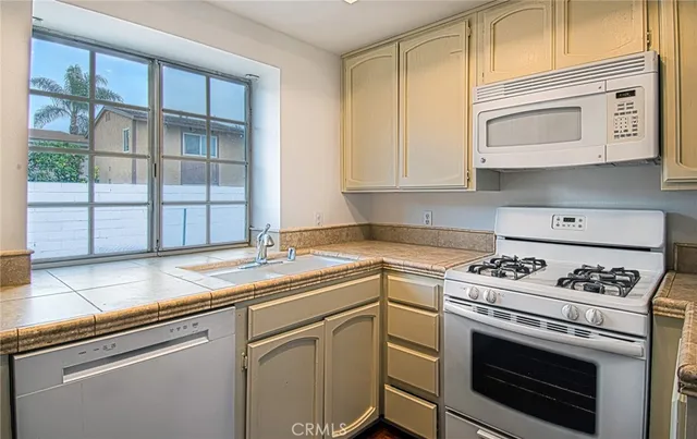 a kitchen with cabinets appliances and a sink