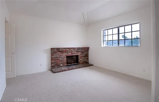 an empty room with a fireplace