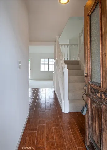 a view of entryway with wooden floor and stairs