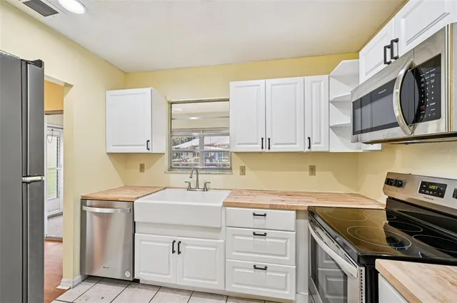 a kitchen with stainless steel appliances granite countertop a sink and a stove