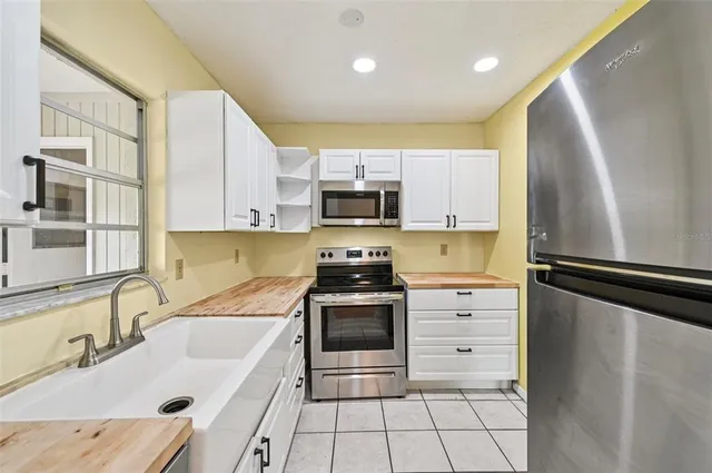 a kitchen with a sink stove and refrigerator