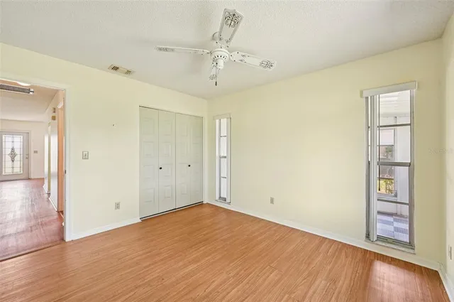 wooden floor in an empty room with a window