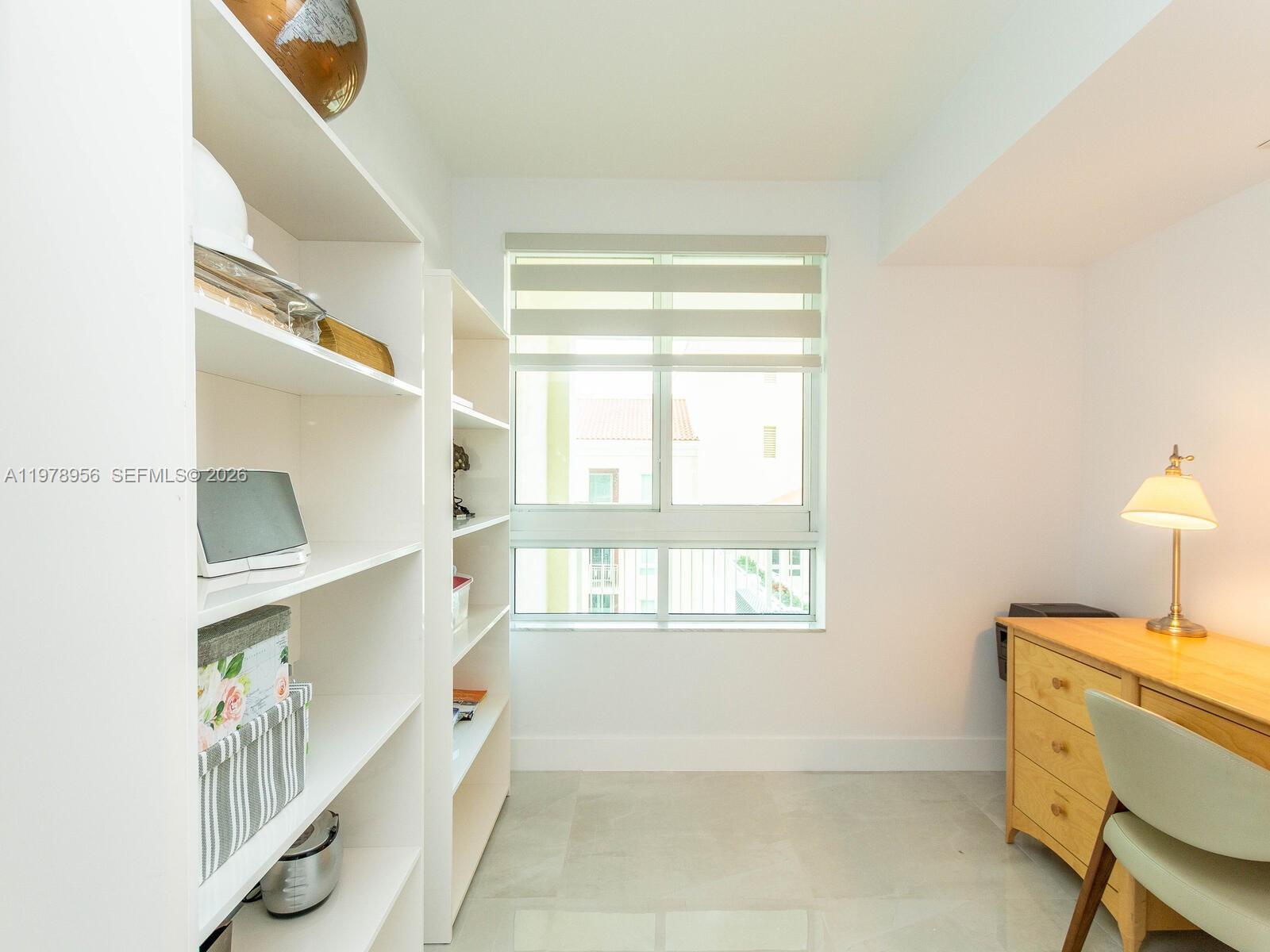 7350 Southwest 89th Street, Unit 719S Miami, FL 33156 - Photo 22 of 30 a room with a window and a table chair