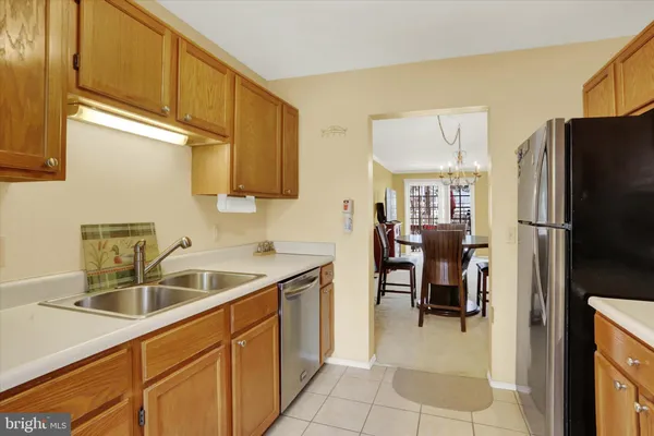 a kitchen with a sink cabinets and refrigerator