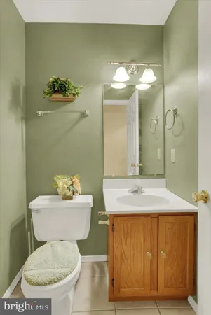 a bathroom with a granite countertop toilet sink and mirror