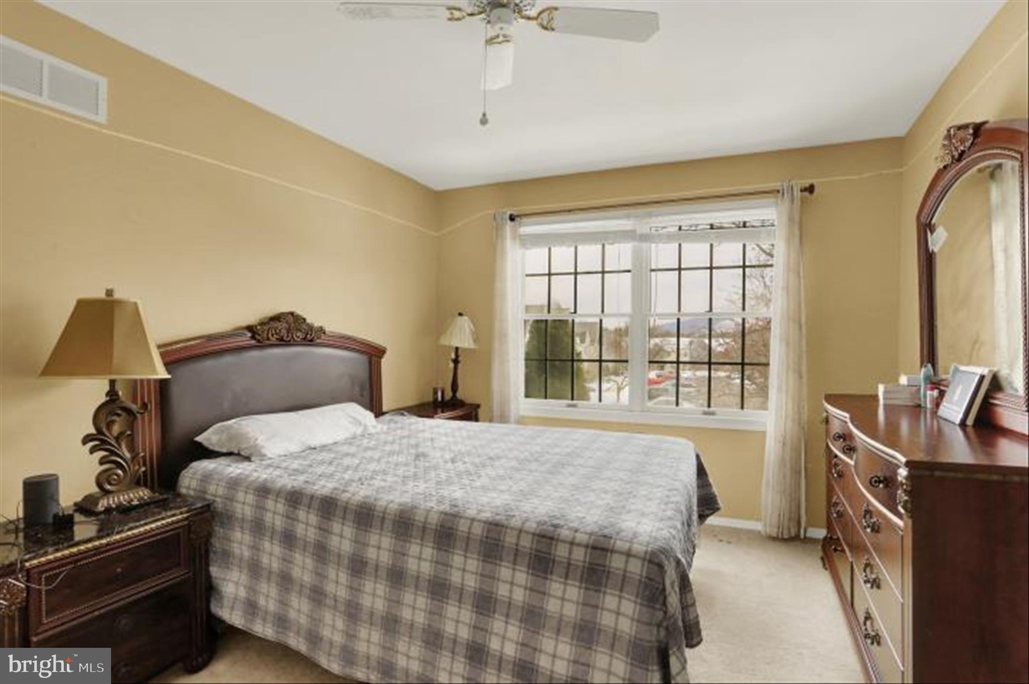 1947 Deer Path Road Harrisburg, PA 17110 - Photo 19 of 32 a bedroom with a bed next to a window with a flat tv screen and dresser