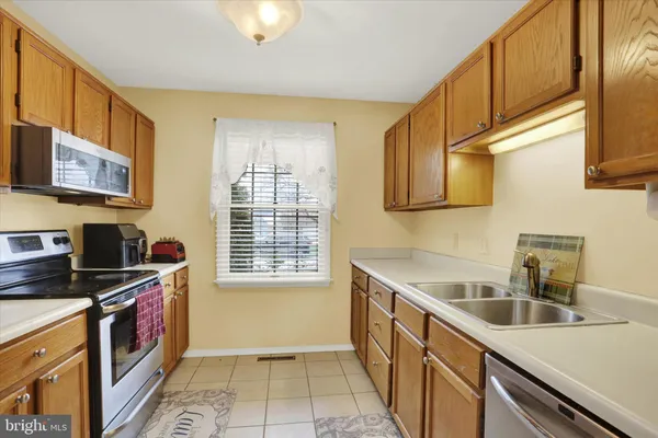 a kitchen that has a sink and a stove