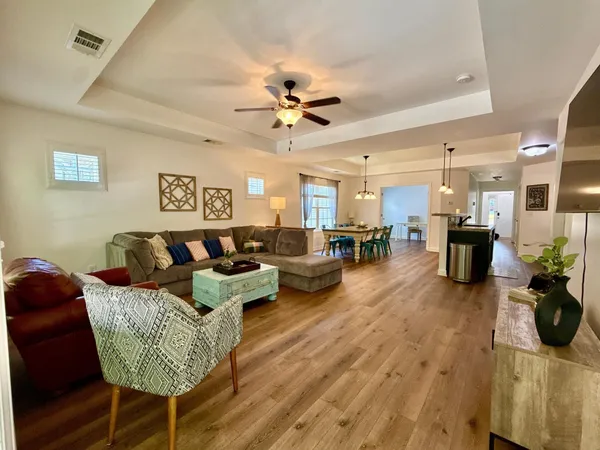 a living room with furniture and a chandelier