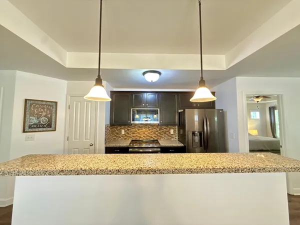 a living room with furniture a dining table and a chandelier