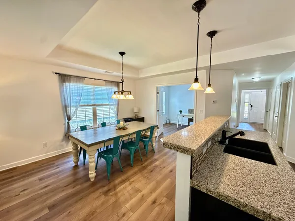 a living room with furniture a flat screen tv and a large window