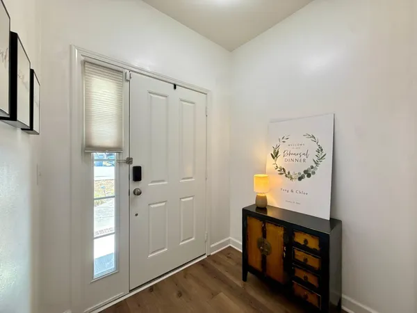 a view of an entryway with wooden floor