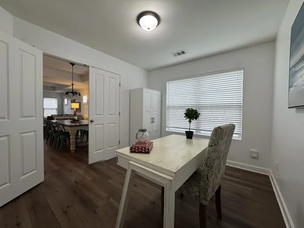 a bedroom with a bed and a flat tv screen on dresser