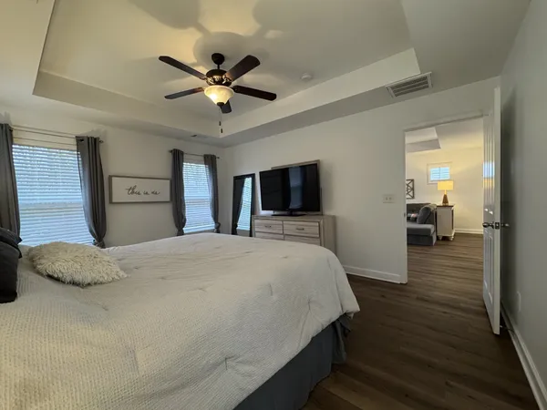 a view of a hallway with wooden floor and closet