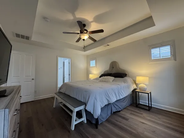 a view of a room with wooden floor and white doors