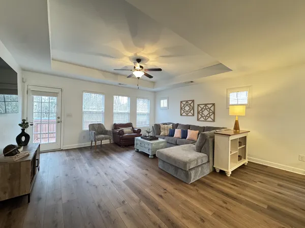 a living room with furniture and wooden floor