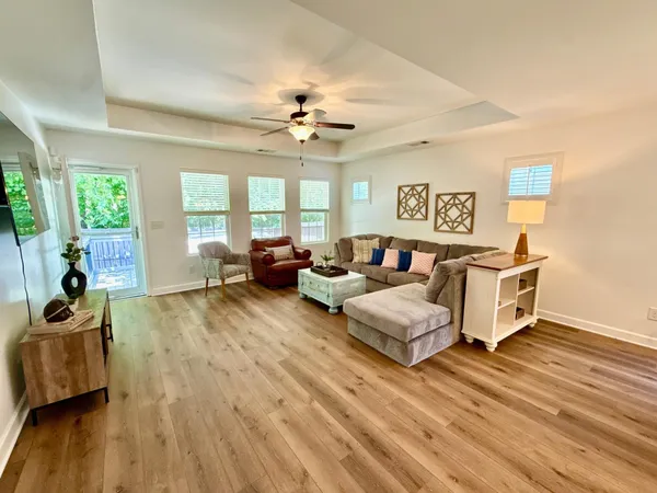 a kitchen with a stove a sink a counter space and wooden floor
