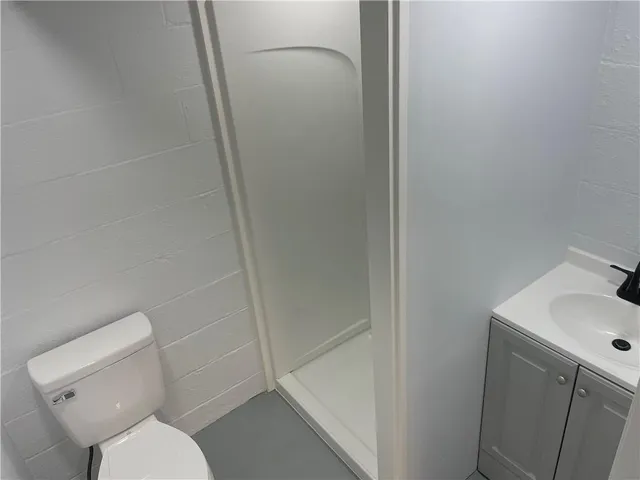 a white toilet sitting next to a bathroom sink