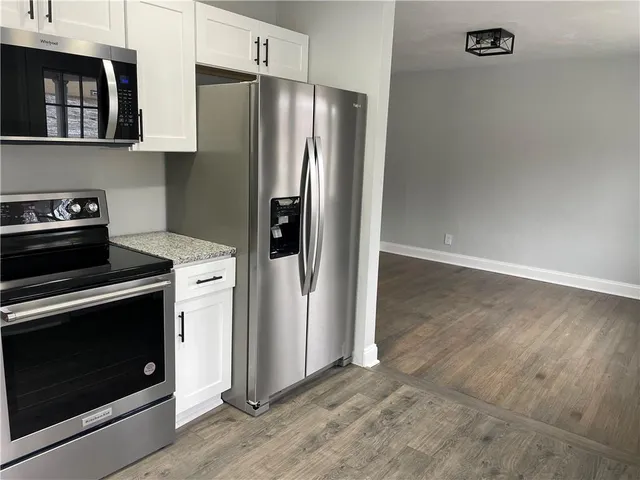 a kitchen with metallic refrigerator and stove