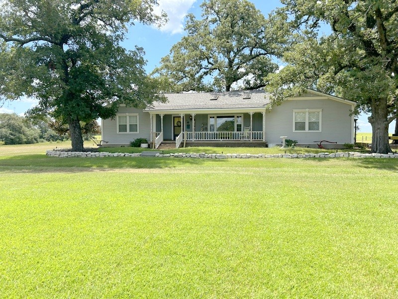 359 Salmon Lake Road Grapeland, TX 75844 - Photo 2 of 49 a view of a house with a big yard and large trees