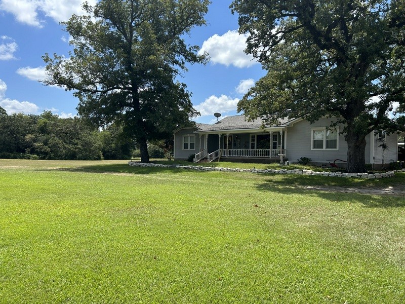 359 Salmon Lake Road Grapeland, TX 75844 - Photo 45 of 49 a front view of a house with swimming pool and trees