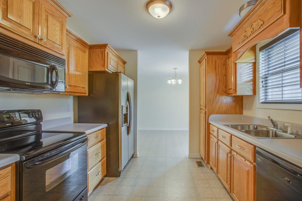 3424 Clegg Drive Spring Hill, TN 37174 - Photo 13 of 28 a kitchen with stainless steel appliances granite countertop a stove a refrigerator and a sink