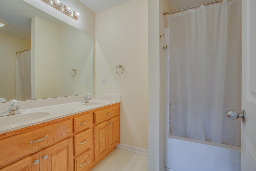 3424 Clegg Drive Spring Hill, TN 37174 - Photo 19 of 28 a bathroom with a double vanity sink and mirror
