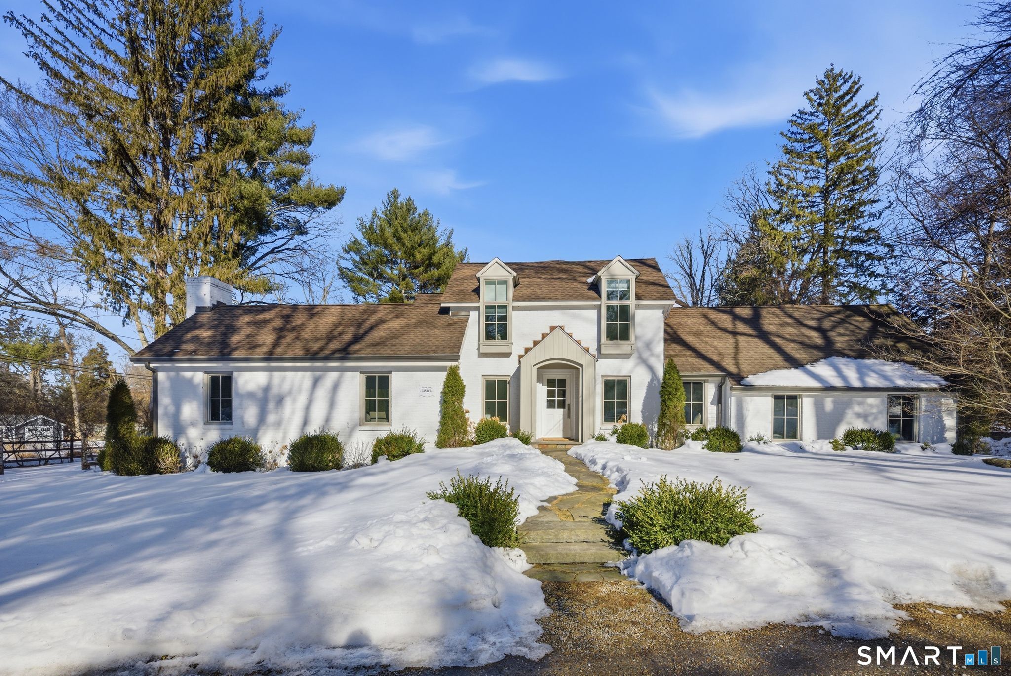 a front view of a house with a garden