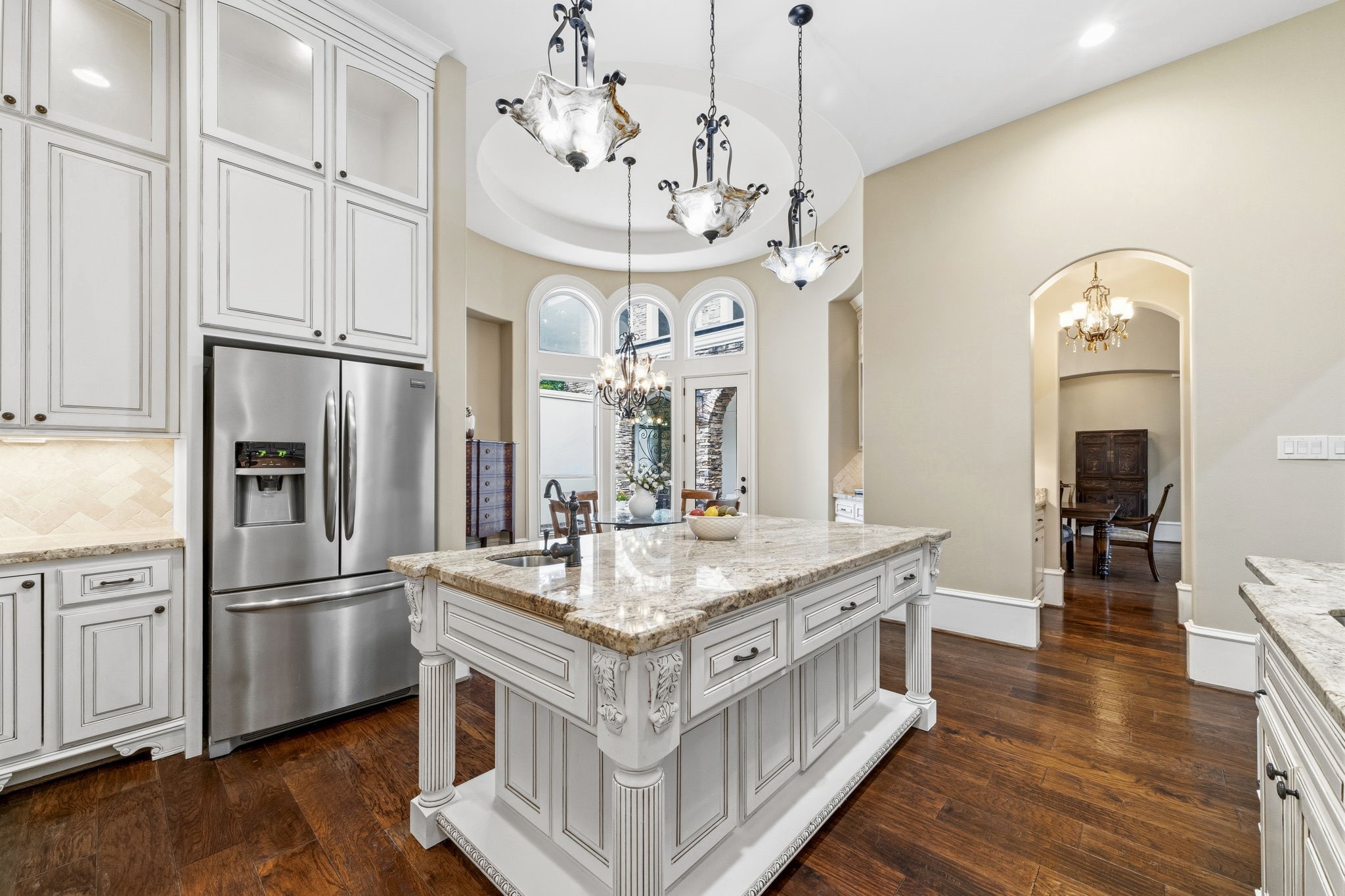 27402 Jacob's Path Lane Spring, TX 77386 - Photo 19 of 48 This view highlights the seamless flow between the kitchen, breakfast room, and butler’s pantry, creating an ideal layout for everyday living and entertaining. The open design allows for easy interaction between spaces while maintaining the home's elegant and functional character.