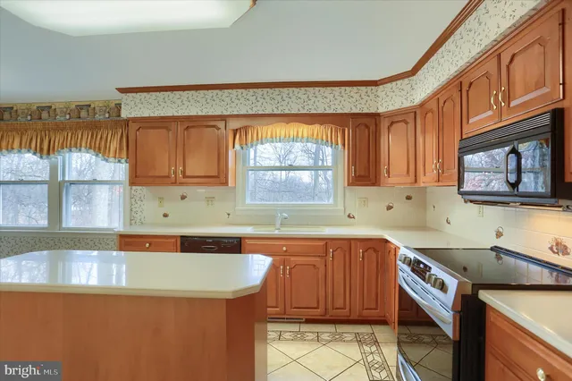 a kitchen with a sink a stove and cabinets