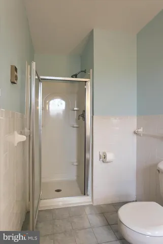a bathroom with a glass shower door