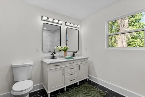 a bathroom with a toilet sink and mirror