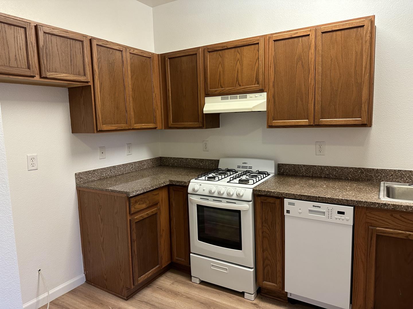 225 Pacifica Boulevard, Unit 101 Watsonville, CA 95076 - Photo 3 of 9 a kitchen with a stove and a sink