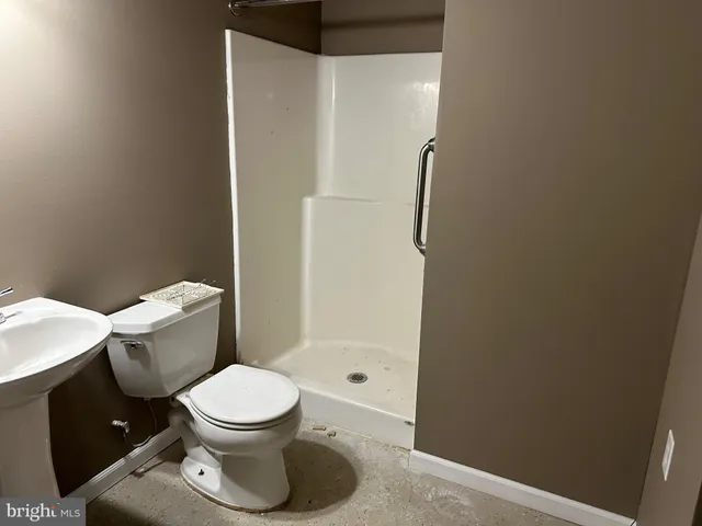 a bathroom with a toilet and a shower