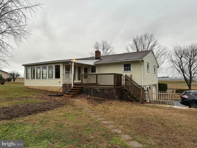 a view of a house with a large window and wooden fence